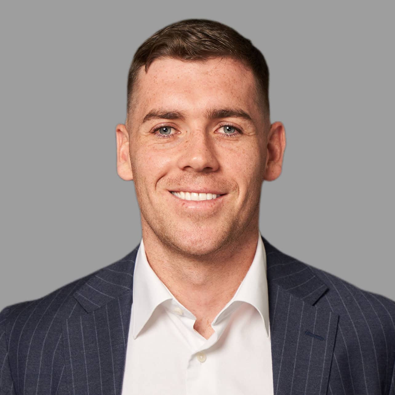 Professional portrait of a smiling man in a suit for Verified Capital.